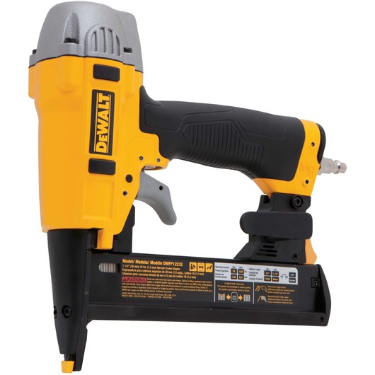 A DEWALT pneumatic nailer with a yellow and black design, featuring a comfortable grip and metal components. The tool has a DEWALT logo on the side and safety warnings on the base.