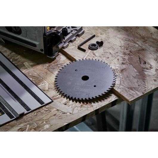 DEWALT DT1088 circular saw blade and accessories on a wooden workbench.