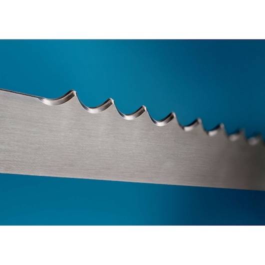 Close-up of a metal saw blade with sharp teeth against a blue background.
