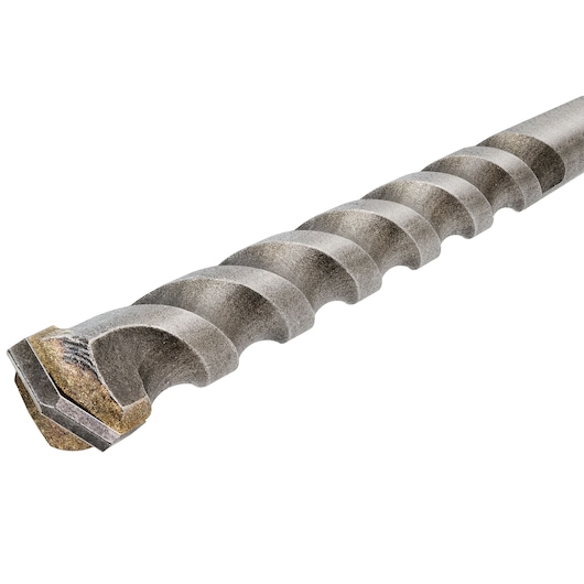 Close-up of a metal drill bit with spiral grooves and a soldered tip, used for drilling masonry and concrete surfaces.