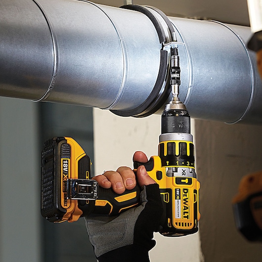 DEWALT DT70578T, DT70578T-QZ drill bit in use on metal duct, photography product.