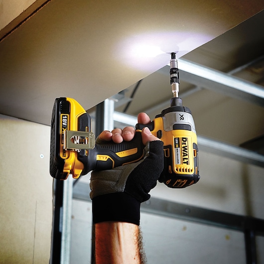 DEWALT drill used on ceiling, DT70578T and DT70578T-QZ SKUs visible. Photography product, EMEAANZ region.