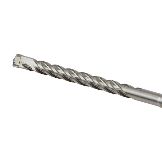 Close-up of a metal DEWALT drill bit with spiral fluting, used for drilling into masonry or concrete surfaces.
