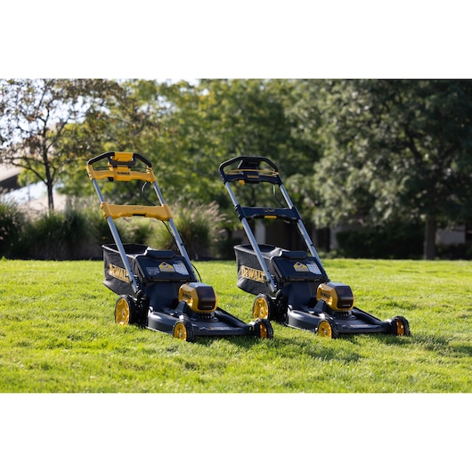 Two DEWALT lawn mowers, SKUs DCMWP134N, DCMWP134W2, DCMWSP156N, DCMWSP156W2, on grass outdoors.
