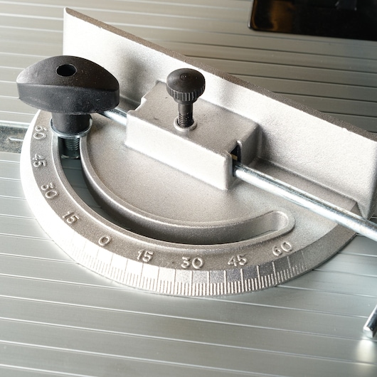 Close-up image of a metal miter gauge used for precise angular measurements on a table saw.