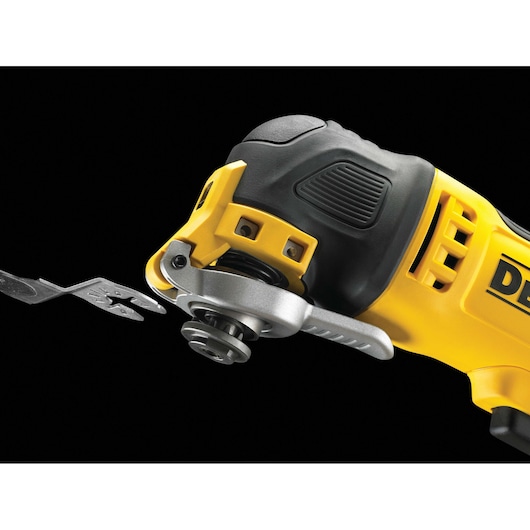 Close-up of a DEWALT electric oscillating multi-tool with a metal cutting blade being attached, featuring a yellow and black design.