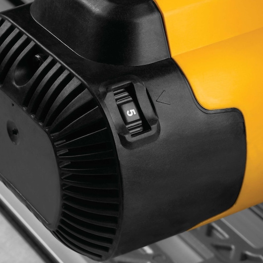 Close-up view of a DEWALT power tool, focusing on the speed adjustment dial set to 5, with a yellow and black housing.