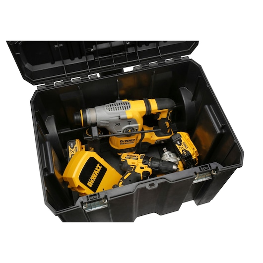 Open black DEWALT storage box containing various yellow and black power tools, including a drill and other equipment.
