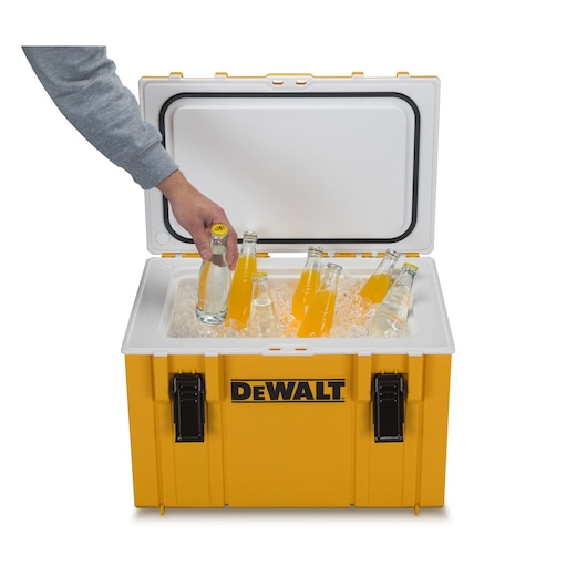 Open yellow DEWALT cooler with bottles on ice, person grabbing a drink.