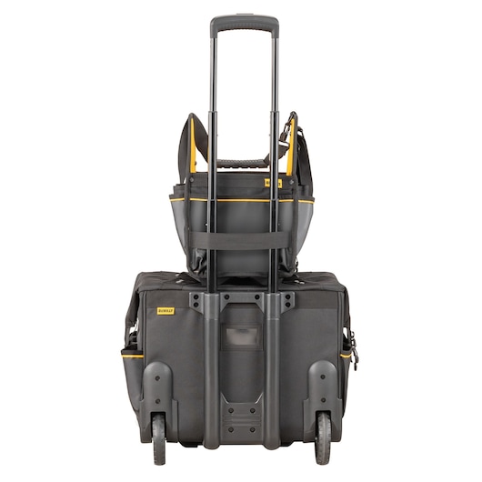 DEWALT rolling tool bag with telescopic handle and a yellow-black tote stacked on top, viewed from the back.