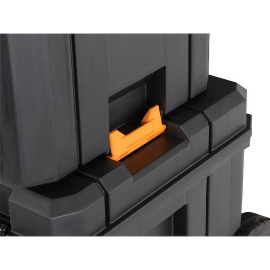 Close-up of stacked black DEWALT toolboxes with orange latch detail.