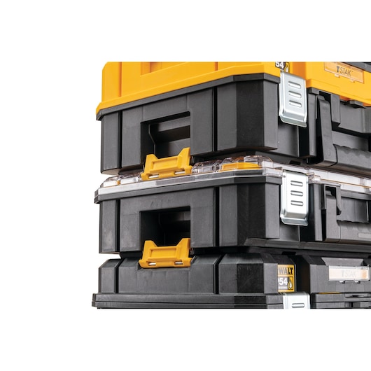 Stacked DEWALT black and yellow tool storage boxes with metal latches and handles, close-up view.