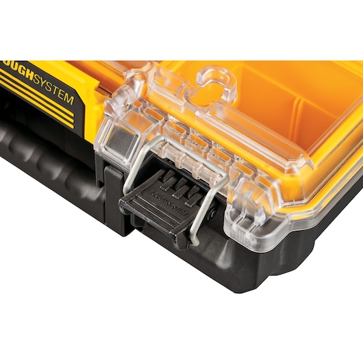 Close-up of a DEWALT ToughSystem storage box with a clear lid and secure latch.