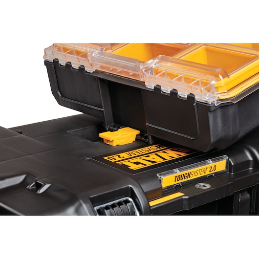 Close-up of DEWALT ToughSystem 2.0 storage box with yellow compartments and clear lid, shown stacked.
