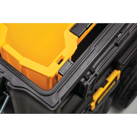 Close-up of DEWALT stackable toolbox with yellow insert and latch detail.