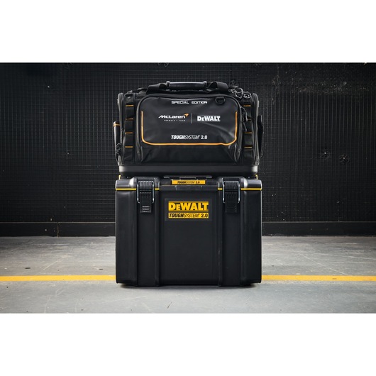 DEWALT ToughSystem 2.0 special edition tool bag and case set stacked on a workshop floor.