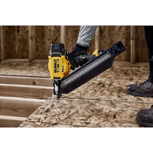 DEWALT nailer in use on wood, model DZN930-XJ, DZN930. Photography product. Construction scene.