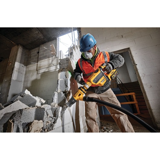 Brushless, cordless SDS MAX combination rotary hammer being used by a person